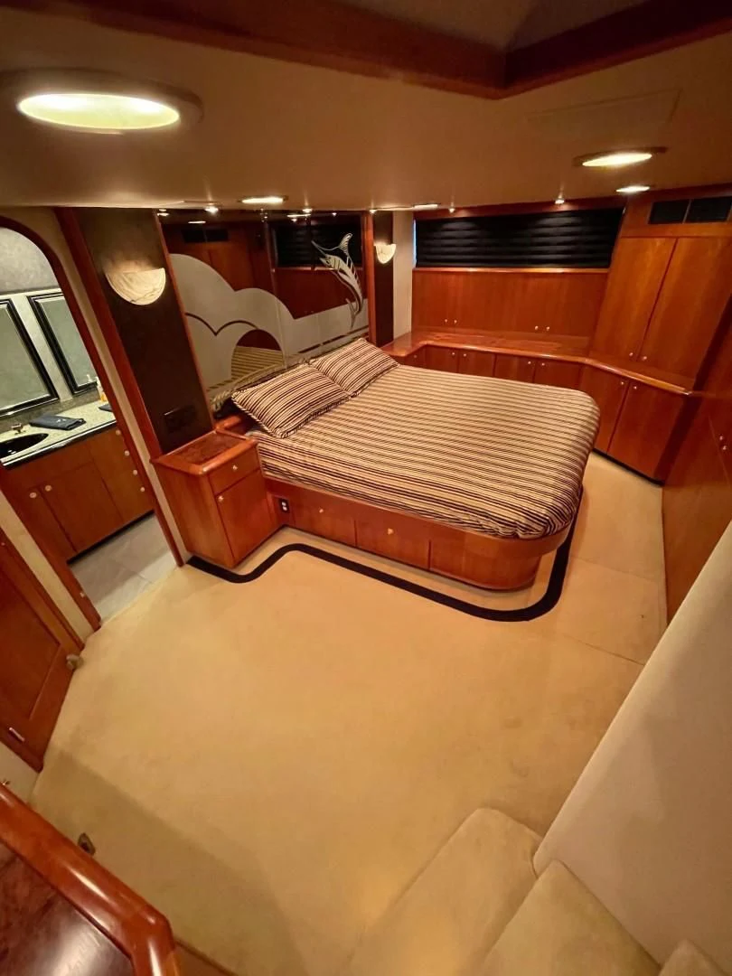 a bedroom with a bed and a desk aboard AFTER MIDNIGHT Yacht for Sale
