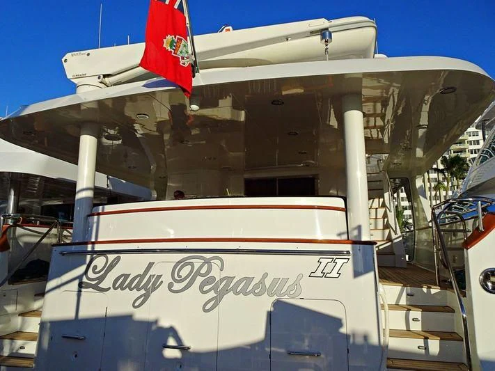 a large white boat with a flag on the front aboard PRINCE OF TIDES Yacht for Sale