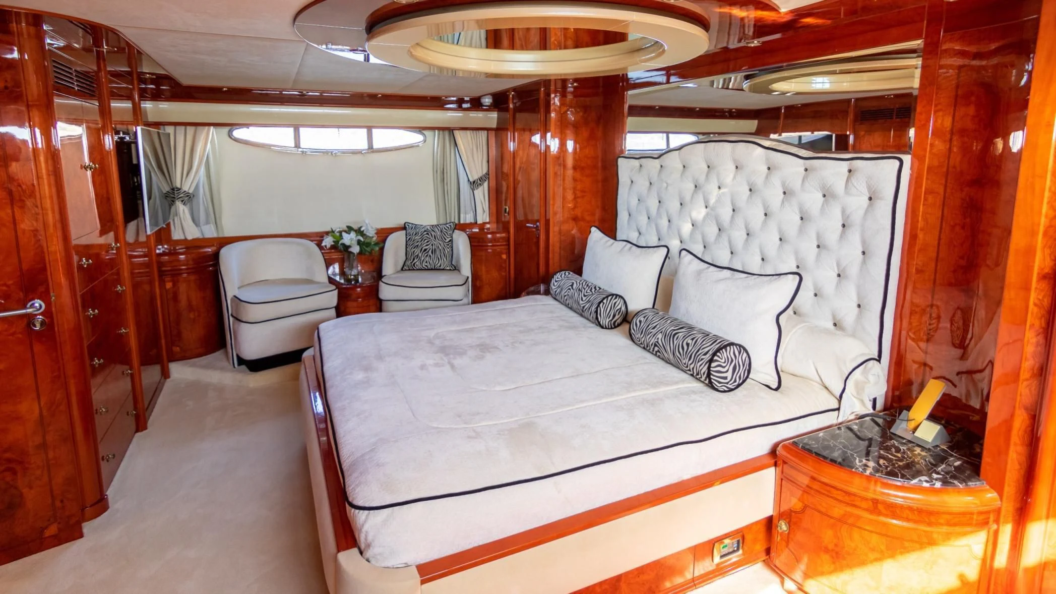 a room with a bed and a chair aboard LADY R Yacht for Sale