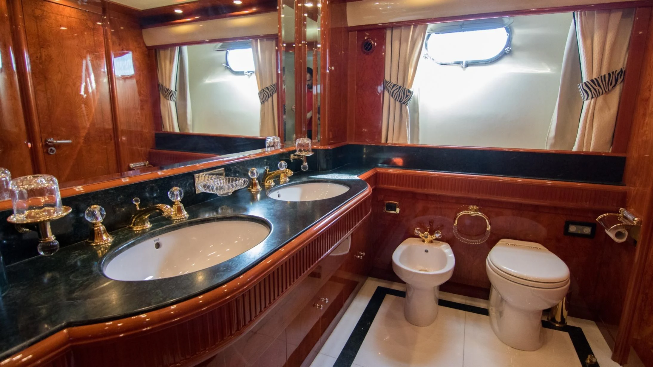 a bathroom with a countertop sink and a toilet aboard LADY R Yacht for Sale