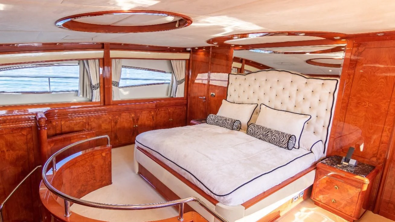 a cabin with a bed and a table aboard LADY R Yacht for Sale