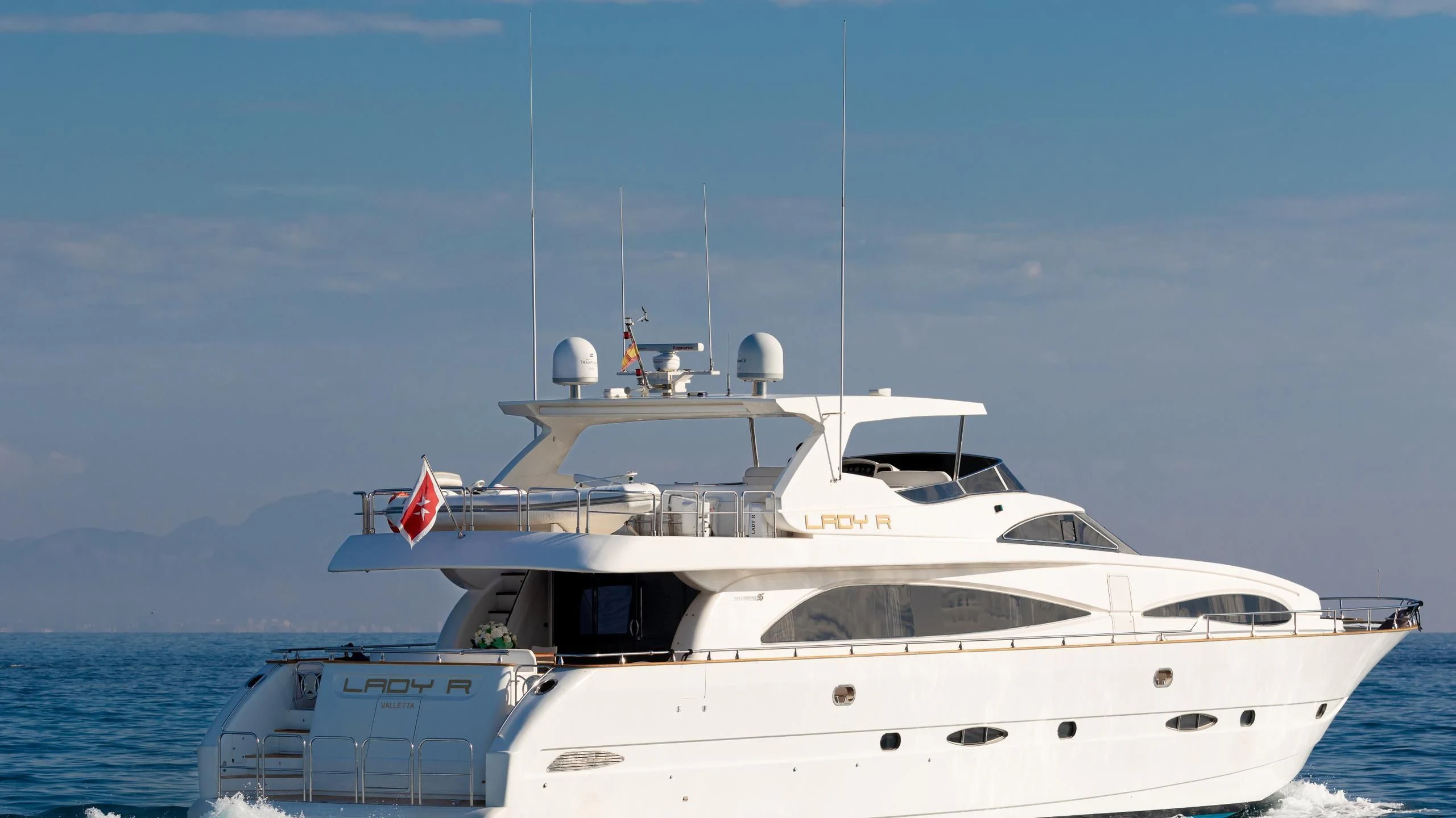 a white yacht on the water aboard LADY R Yacht for Sale