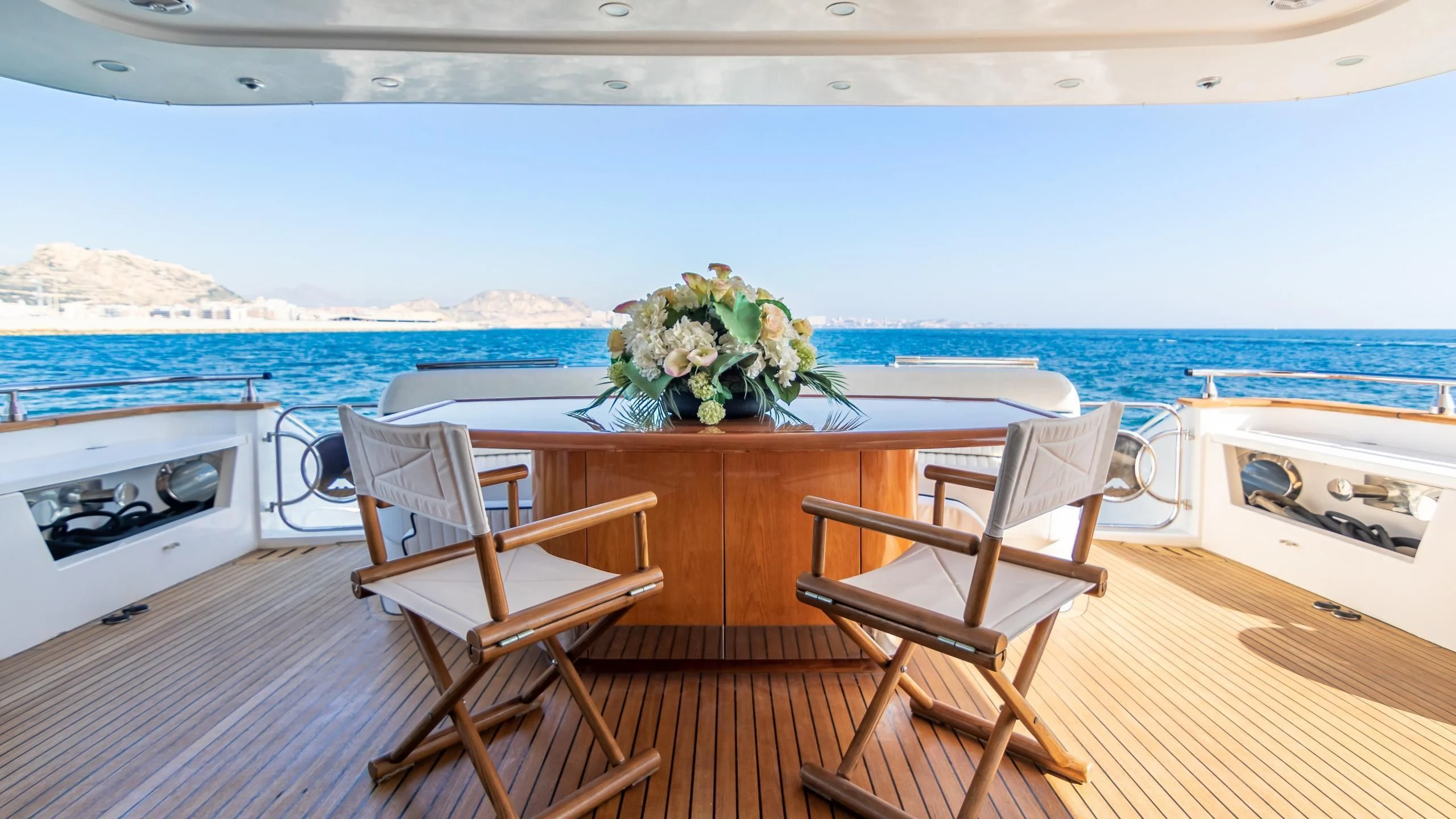a table and chairs on a deck aboard LADY R Yacht for Sale