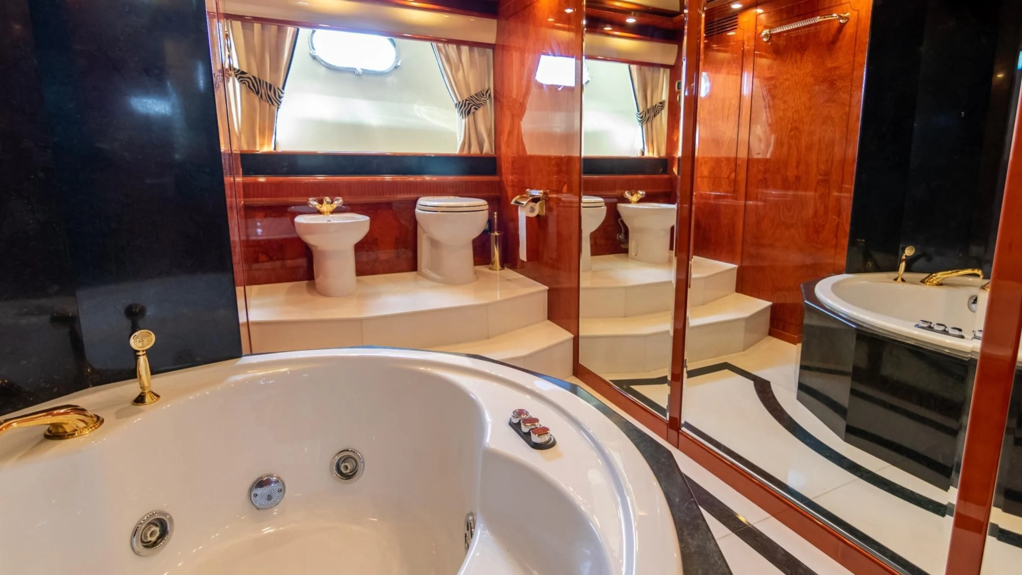 a bathroom with a bathtub and toilet aboard LADY R Yacht for Sale