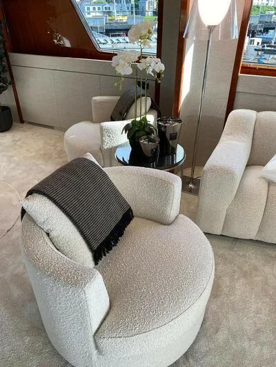 a living room with white furniture aboard BY Yacht for Sale