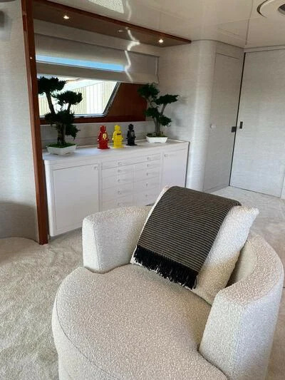 a white living room with a white sofa and white cabinets aboard BY Yacht for Sale