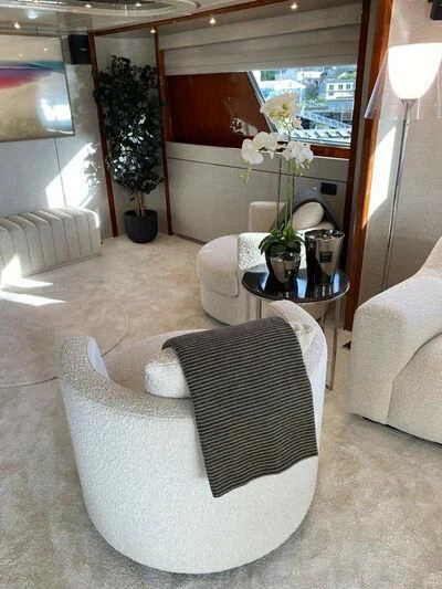 a living room with white furniture aboard BY Yacht for Sale