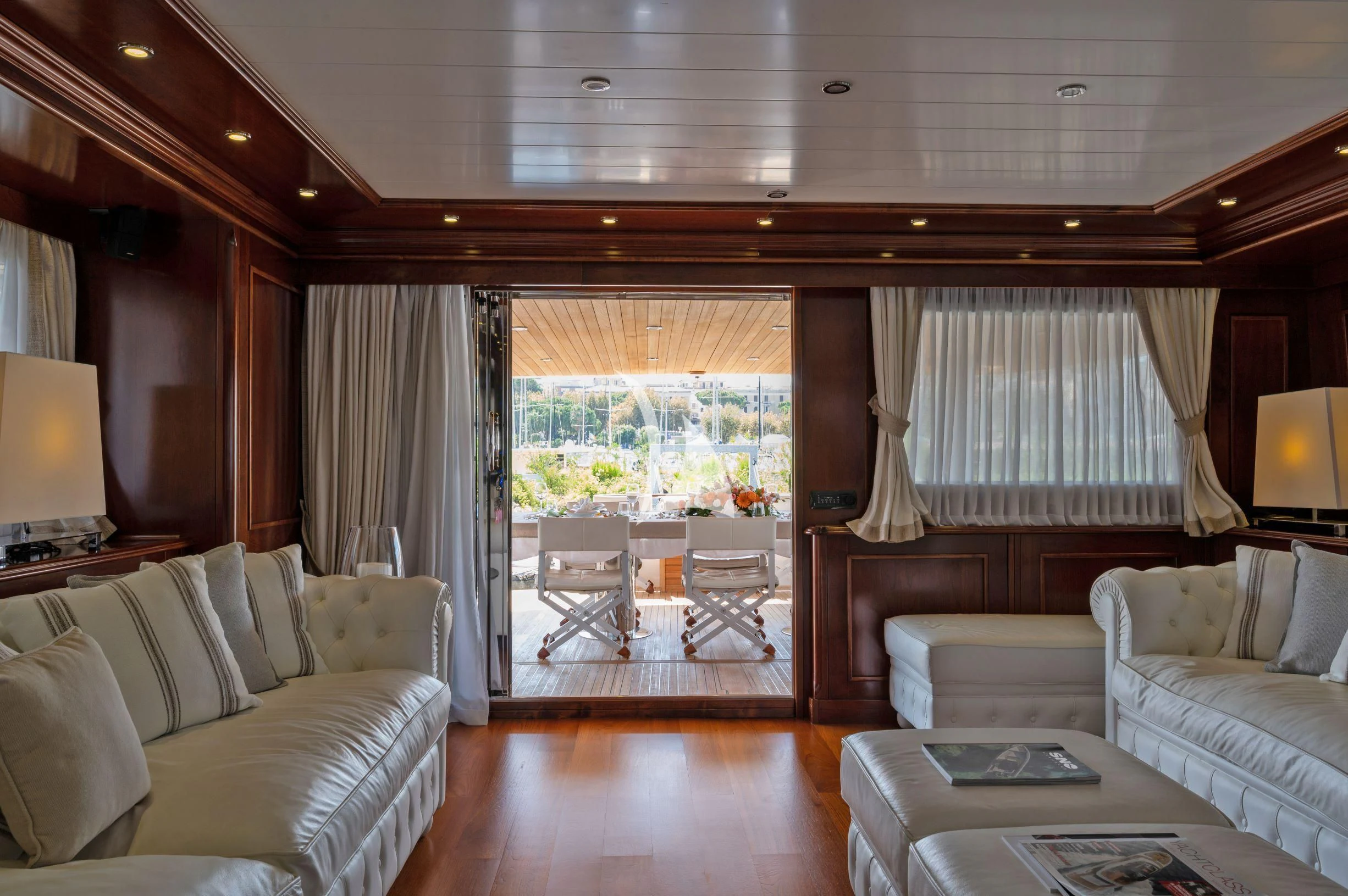 a living room with a large window aboard TANANAI Yacht for Sale