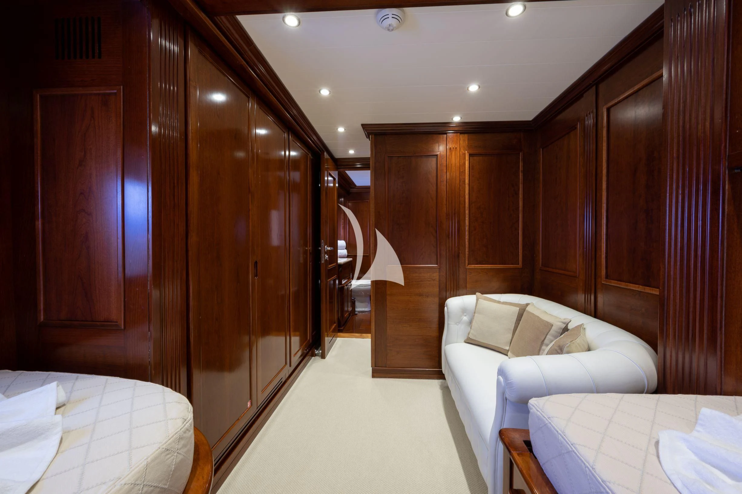 a room with a bed and a closet aboard TANANAI Yacht for Sale