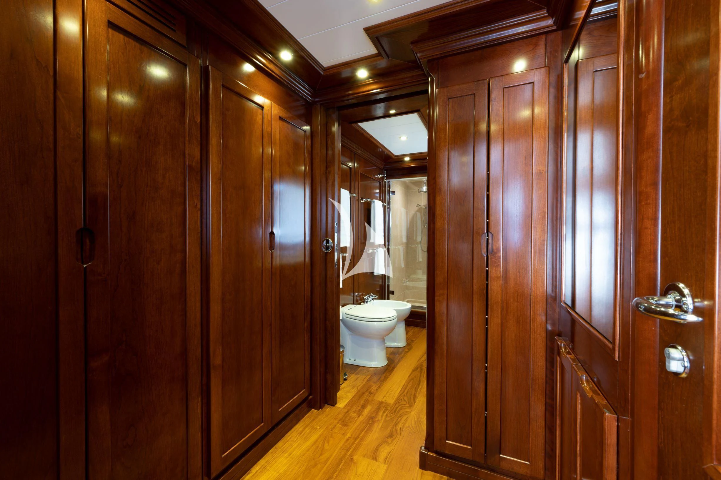 a bathroom with wooden cabinets aboard TANANAI Yacht for Sale