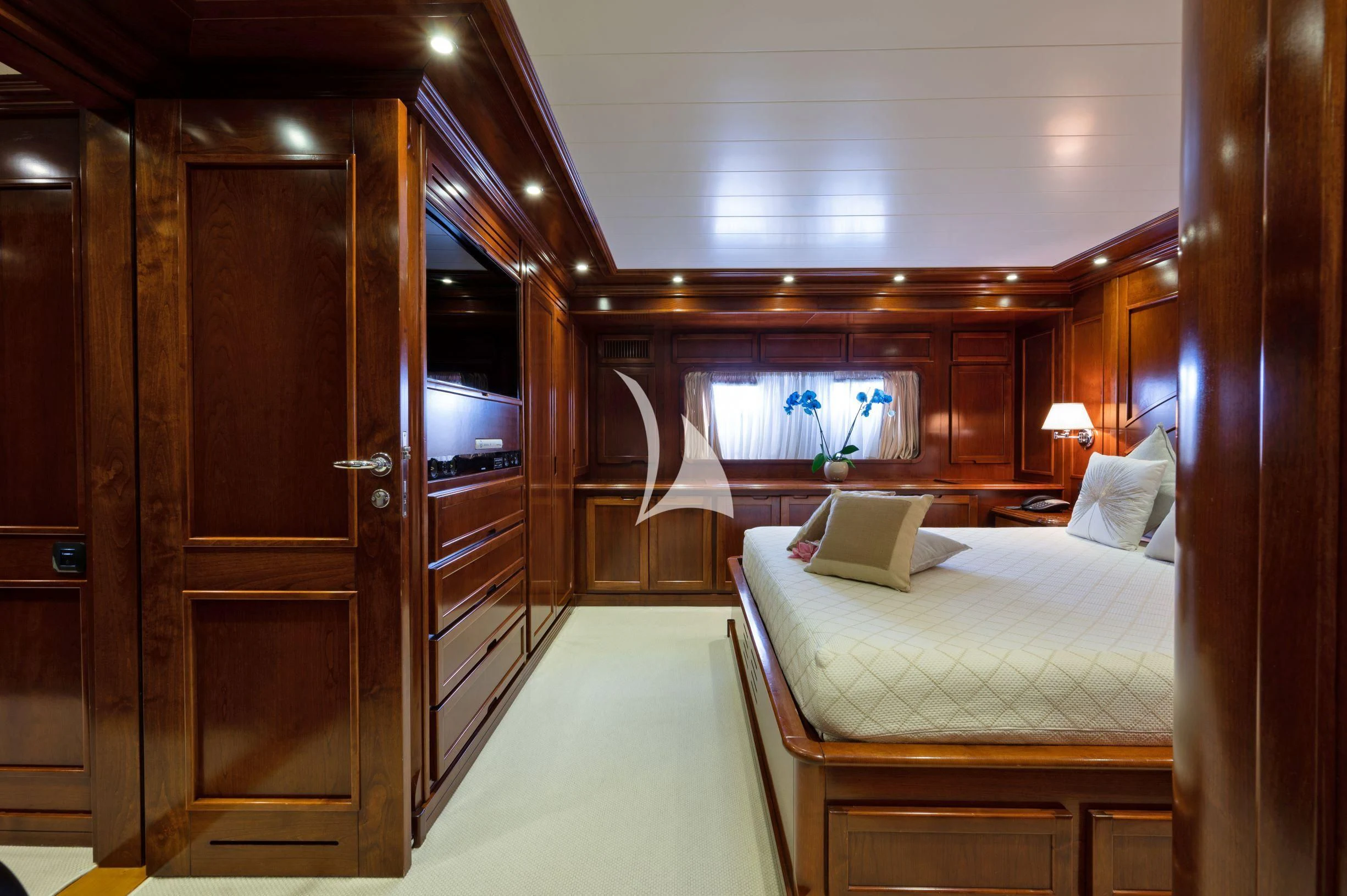 a room with a bed and a door aboard TANANAI Yacht for Sale