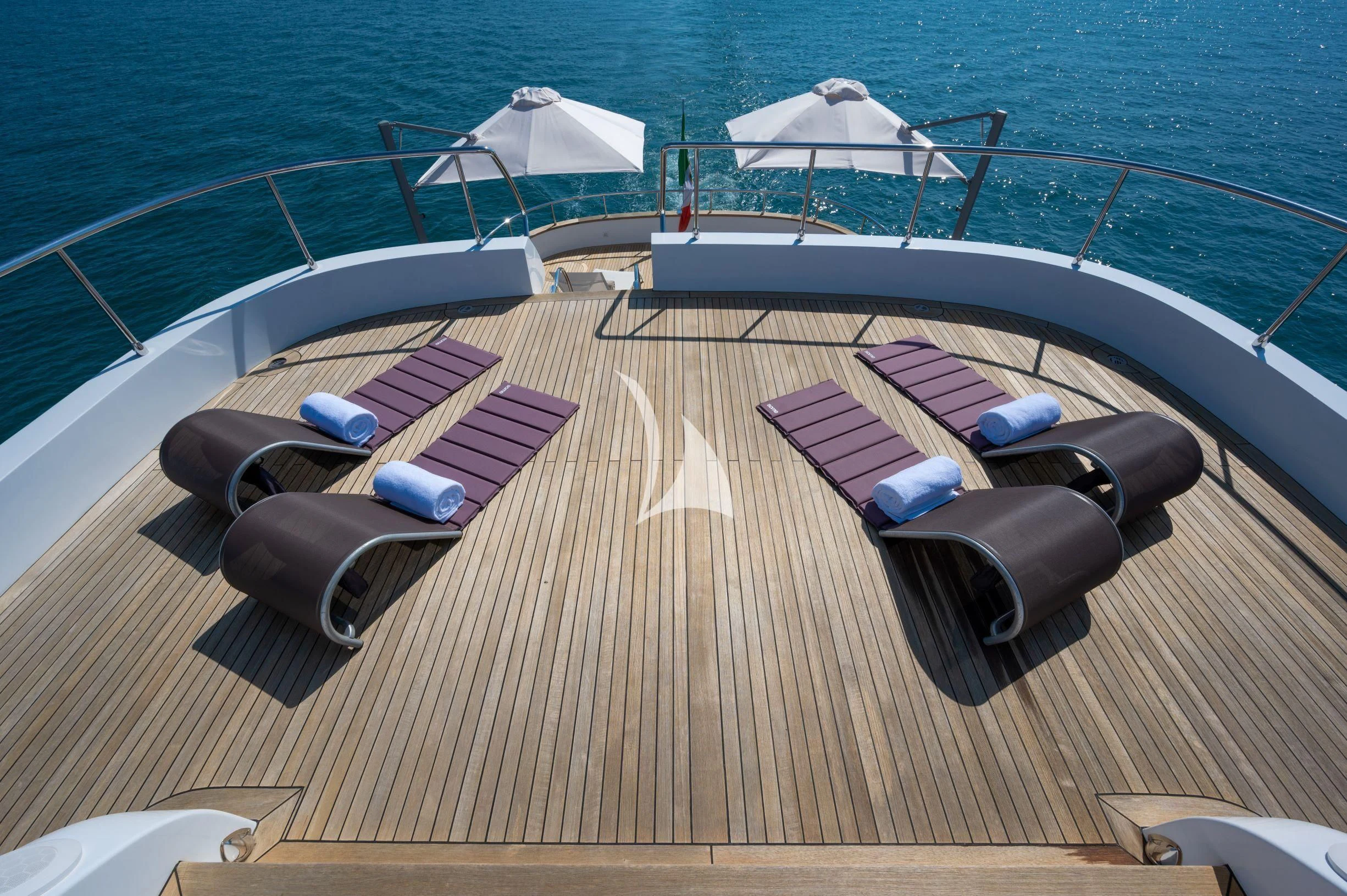 a deck with a boat and a pool on it aboard TANANAI Yacht for Sale
