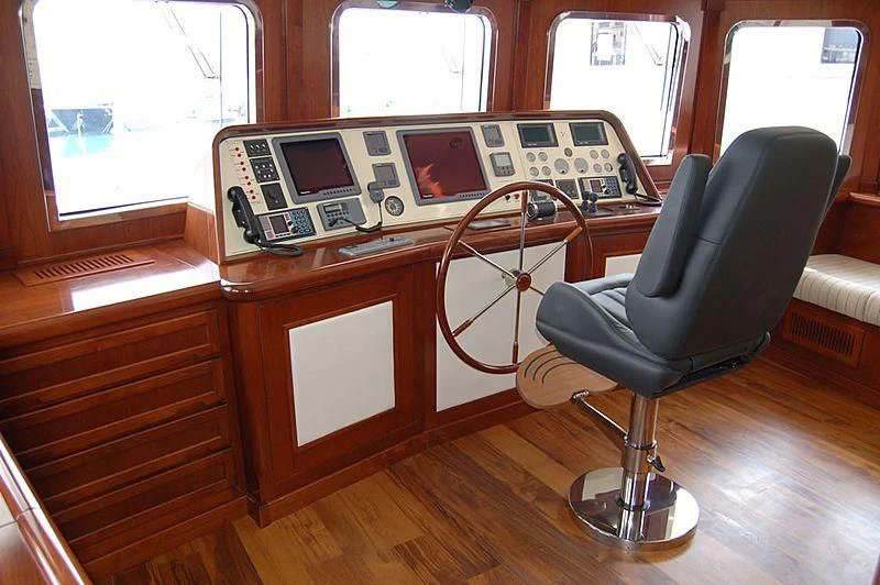 a chair next to a desk aboard TANANAI Yacht for Sale