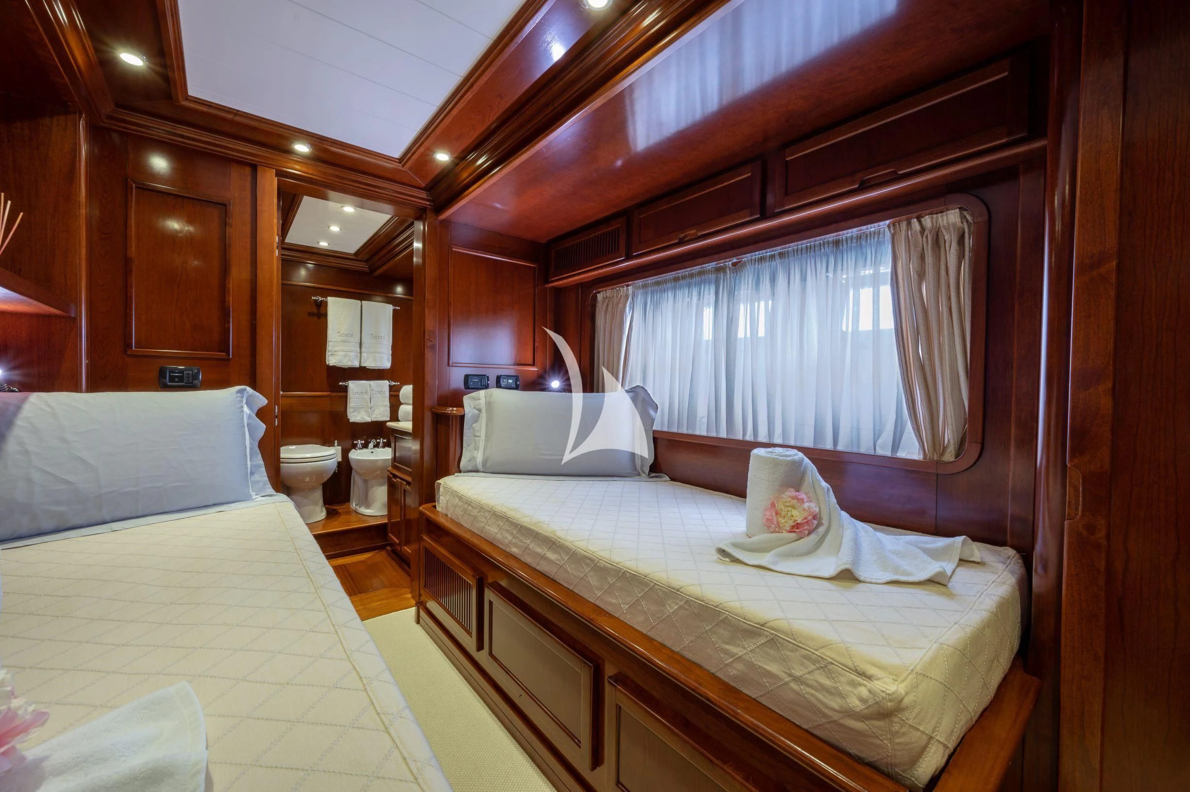 a room with two beds aboard TANANAI Yacht for Sale