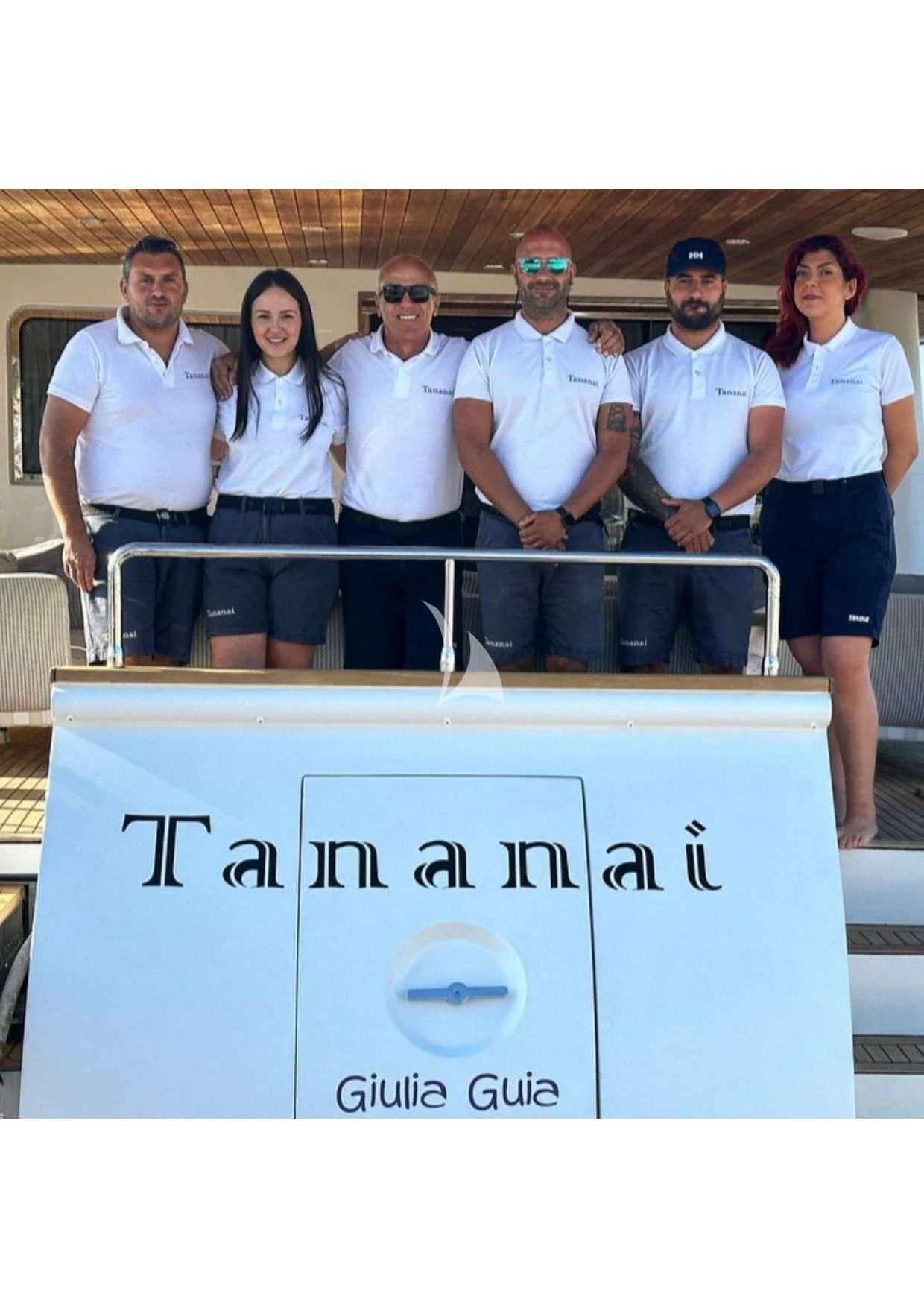 a group of people posing for a photo aboard TANANAI Yacht for Sale