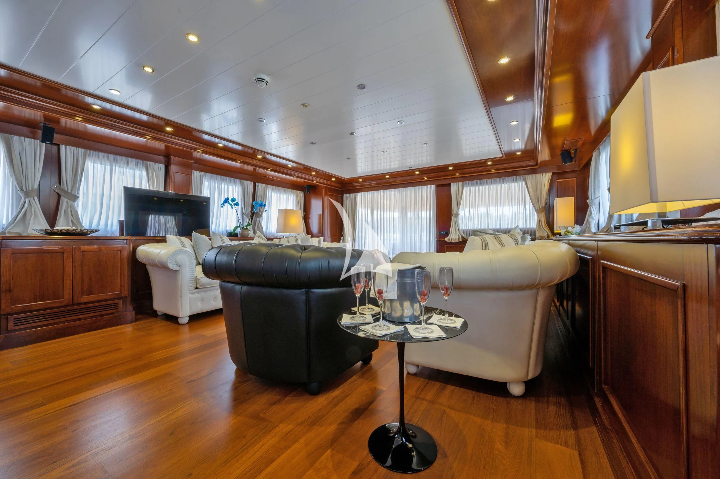 a living room with a wood floor aboard TANANAI Yacht for Sale