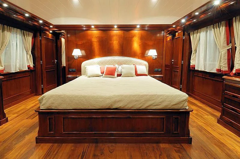 a bed in a room aboard TANANAI Yacht for Sale