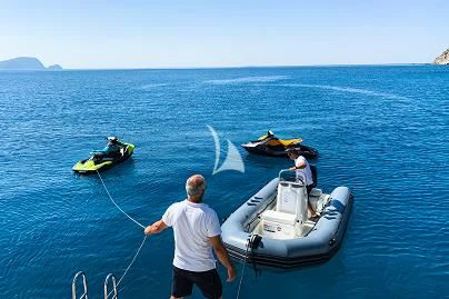 a person standing next to a boat aboard TANANAI Yacht for Sale