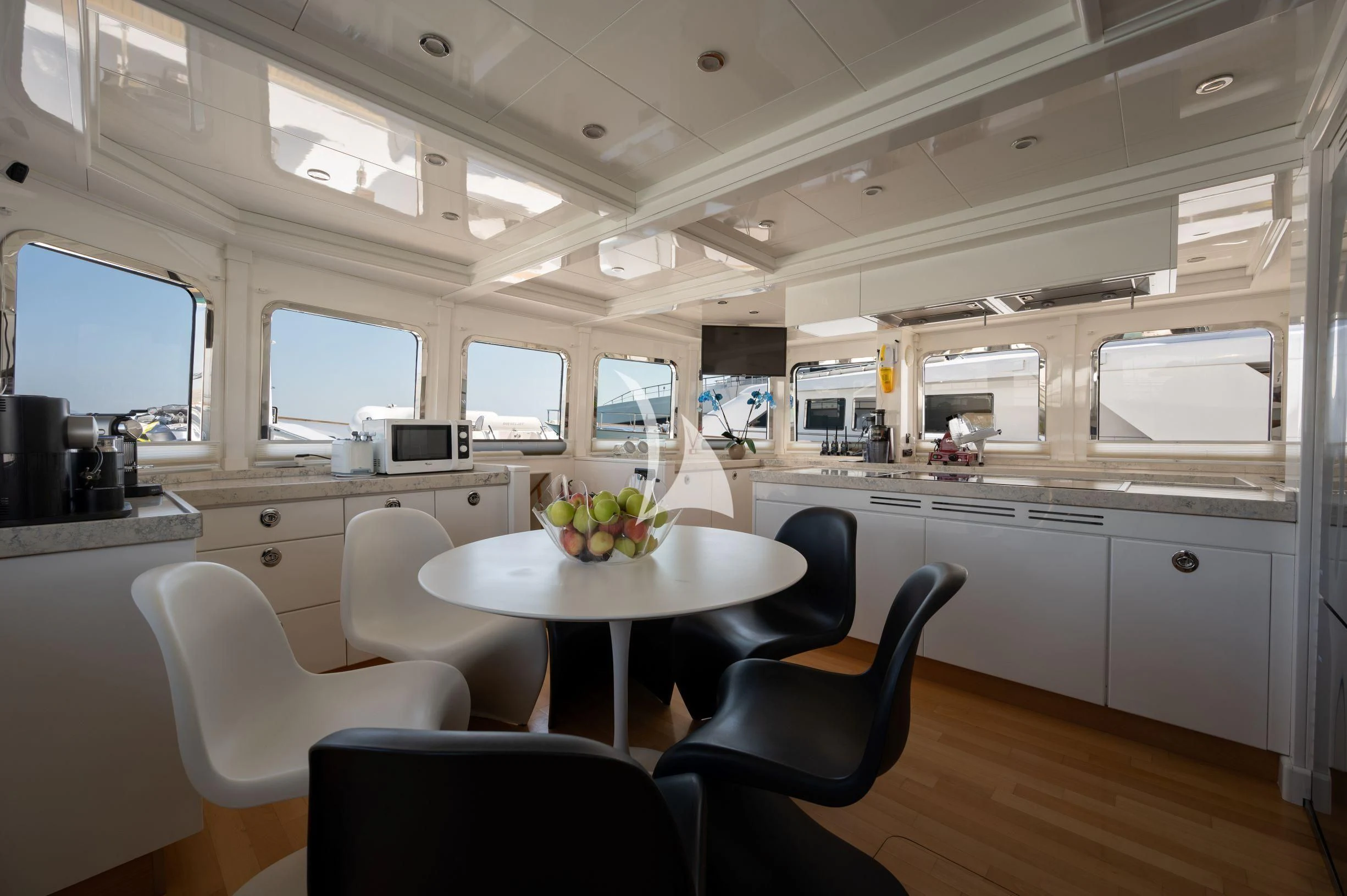 a kitchen with a table and chairs aboard TANANAI Yacht for Sale