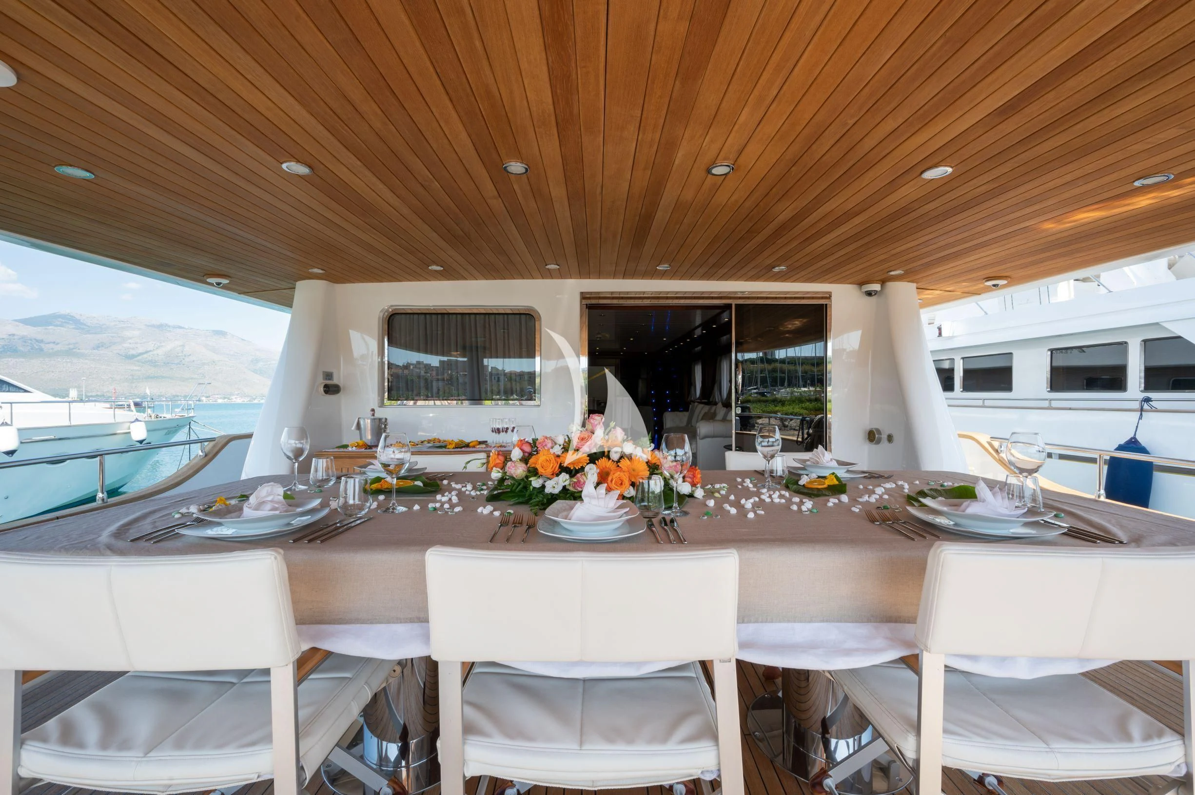 a table with white chairs and white chairs on it aboard TANANAI Yacht for Sale