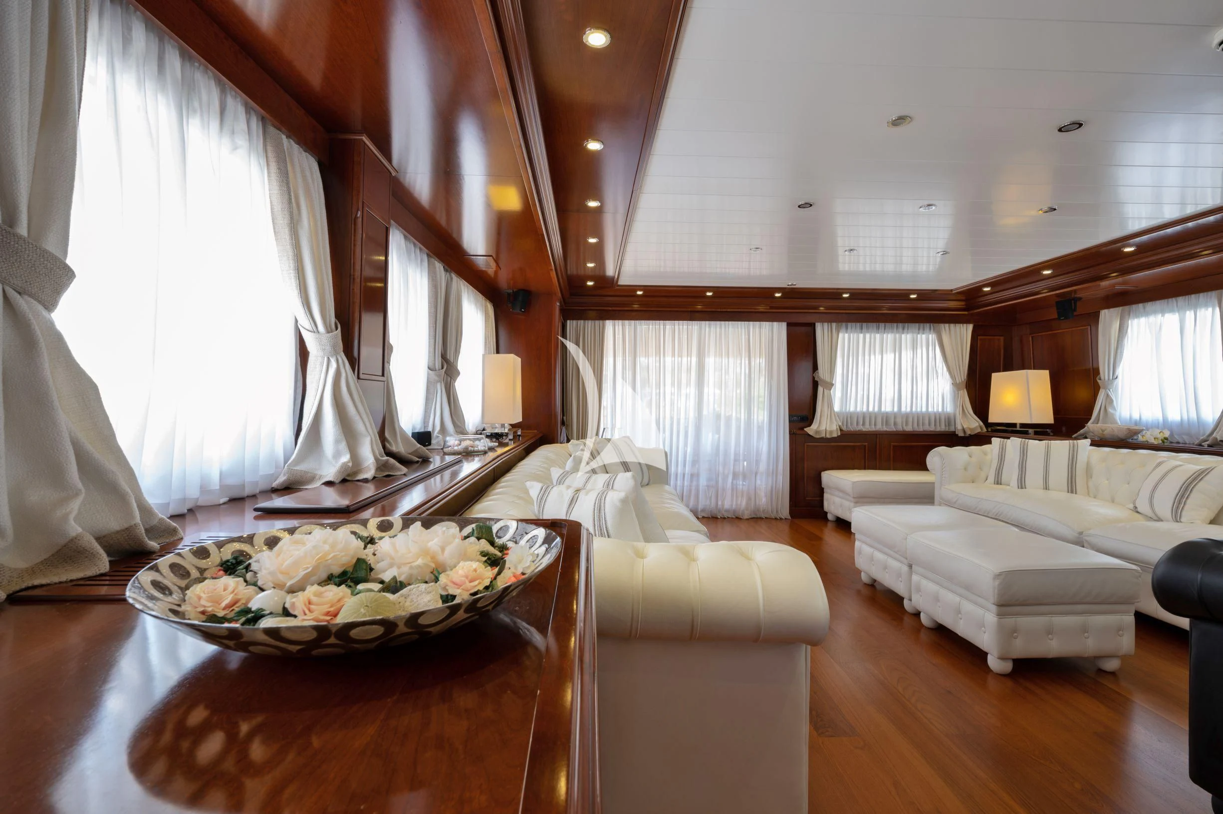 a large room with a table and couches aboard TANANAI Yacht for Sale