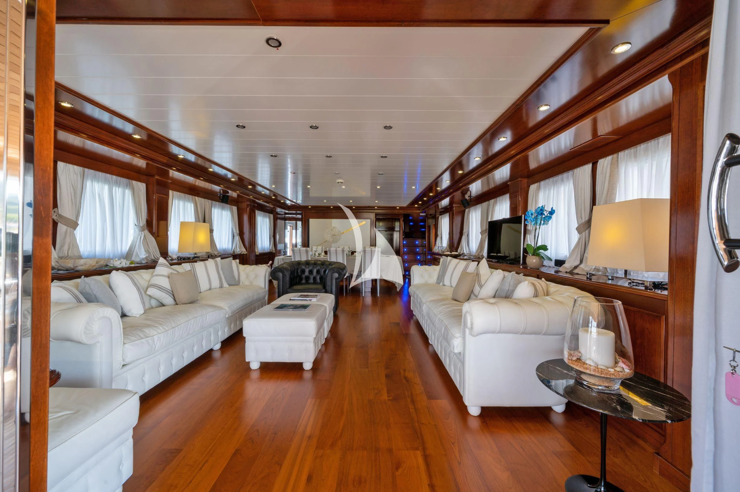 a living room with a wood floor aboard TANANAI Yacht for Sale