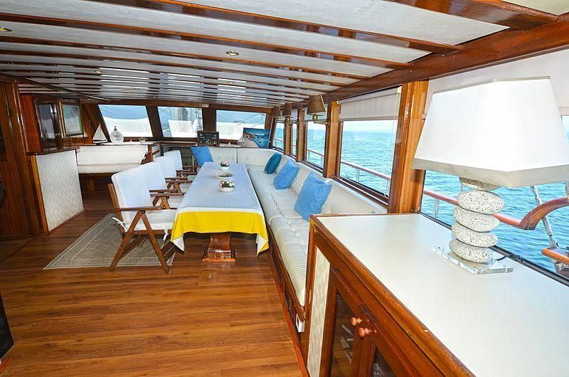 a room with a bed and a table aboard WHITE SWAN Yacht for Sale