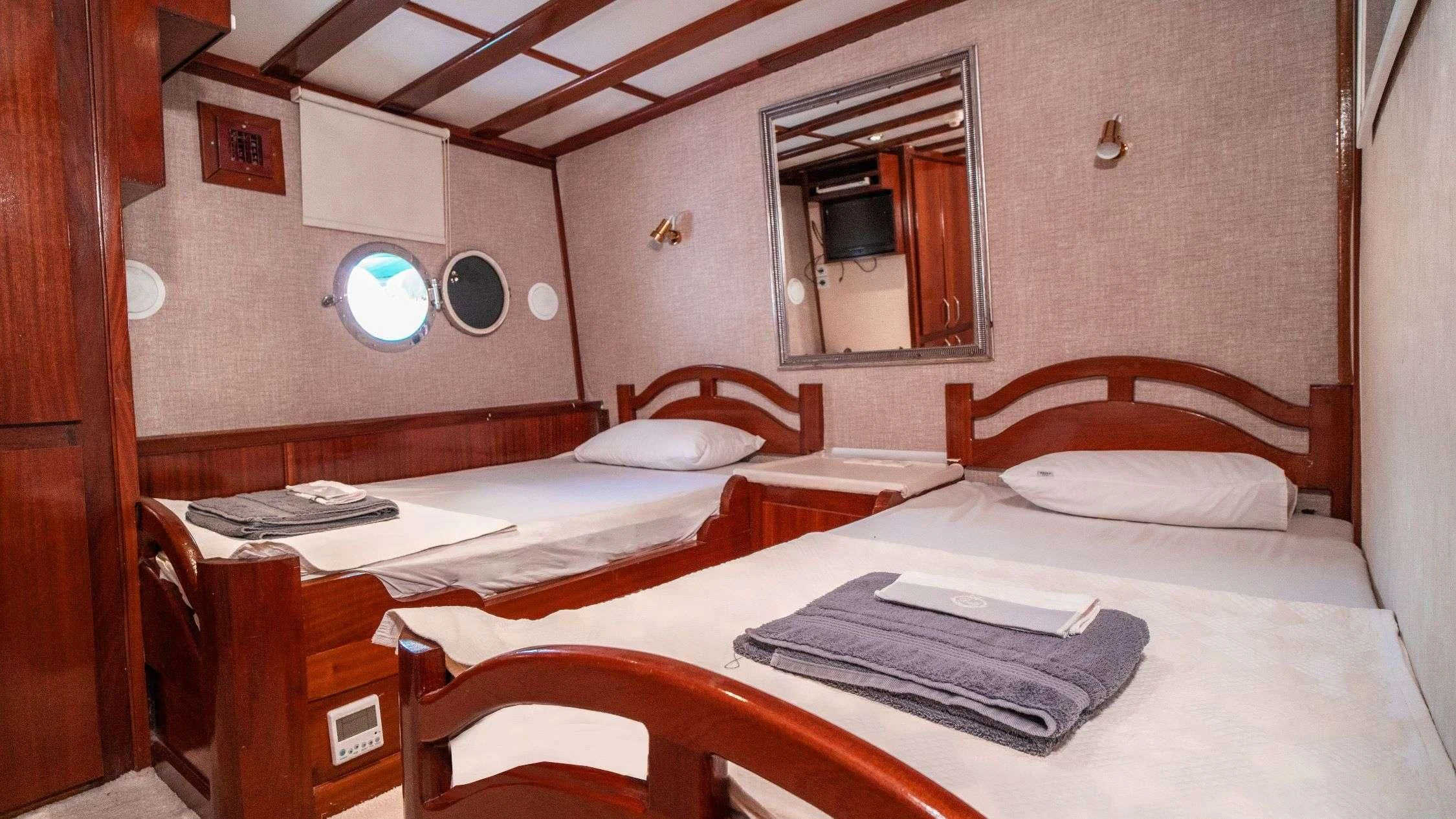 a room with two beds aboard WHITE SWAN Yacht for Sale