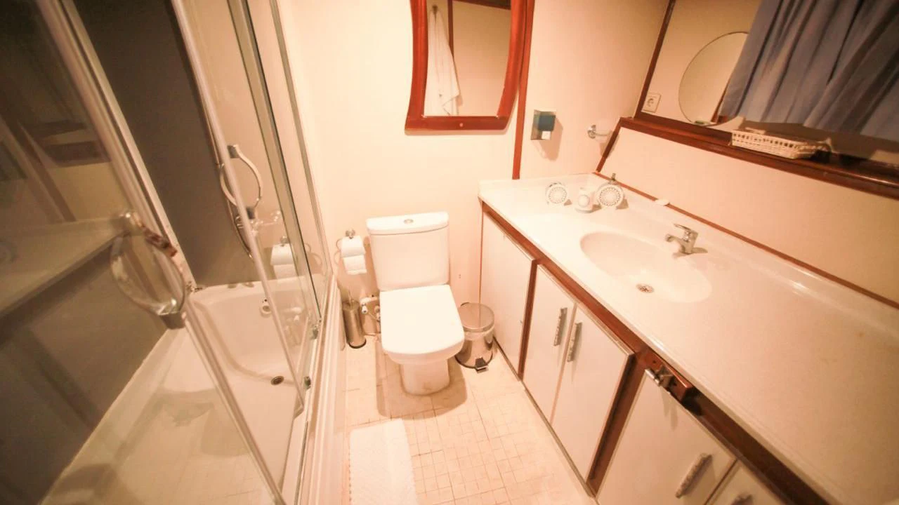 a bathroom with a sink toilet and bathtub aboard WHITE SWAN Yacht for Sale