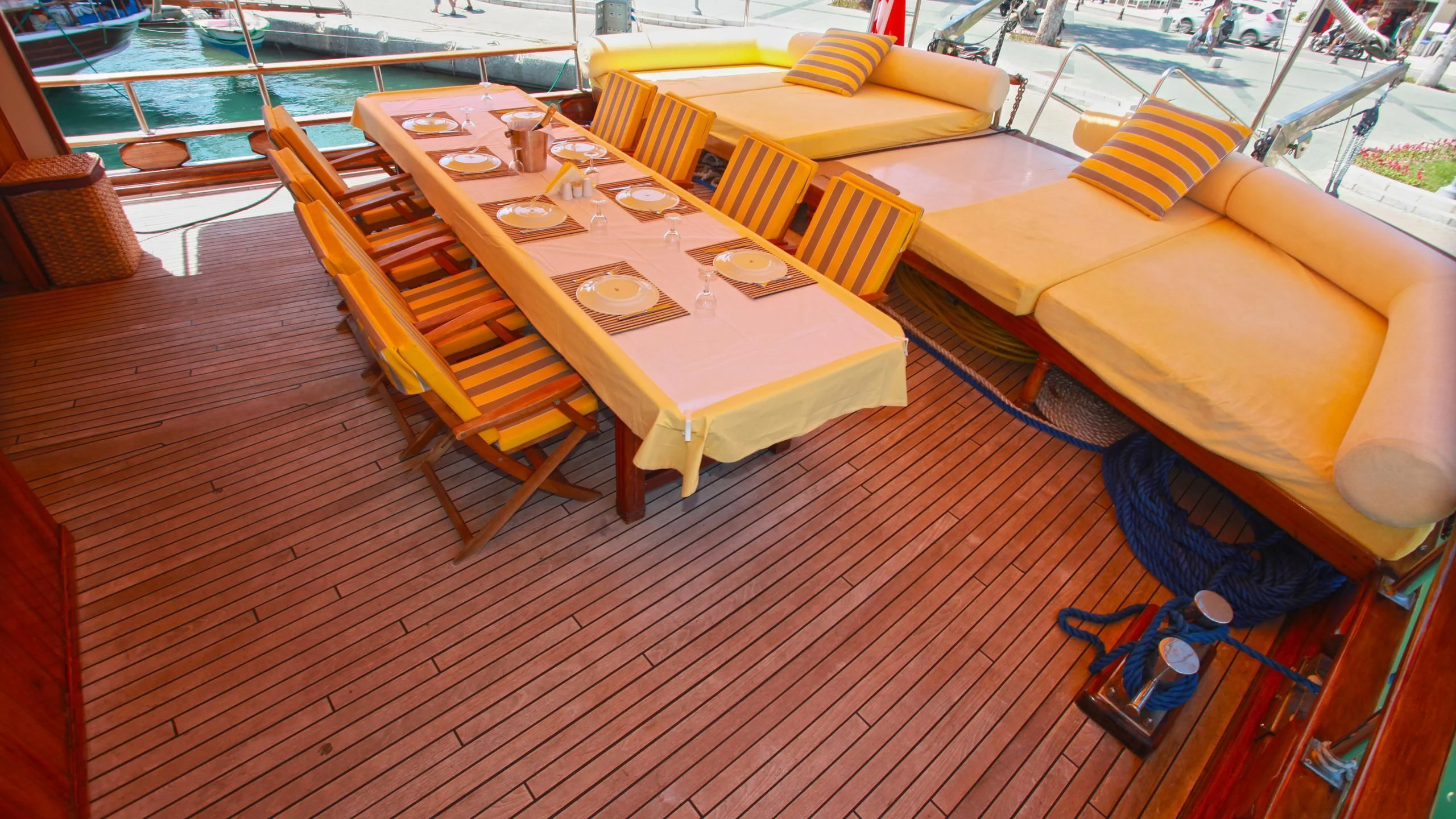 a table set with chairs and a couch on a deck aboard WHITE SWAN Yacht for Sale