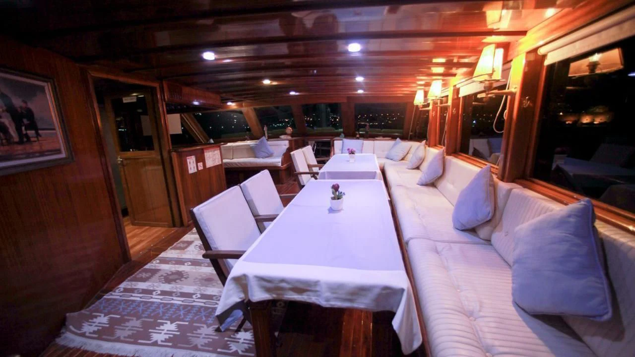 a room with tables and chairs aboard WHITE SWAN Yacht for Sale