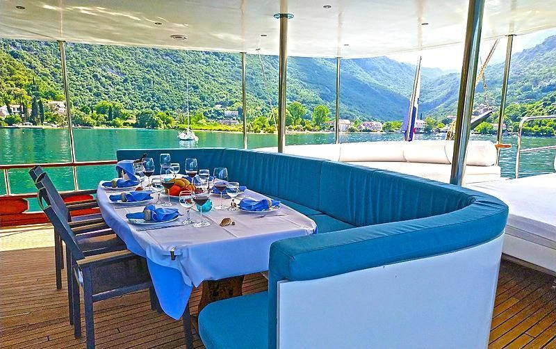 a table and chairs on a deck aboard WHITE SWAN Yacht for Sale