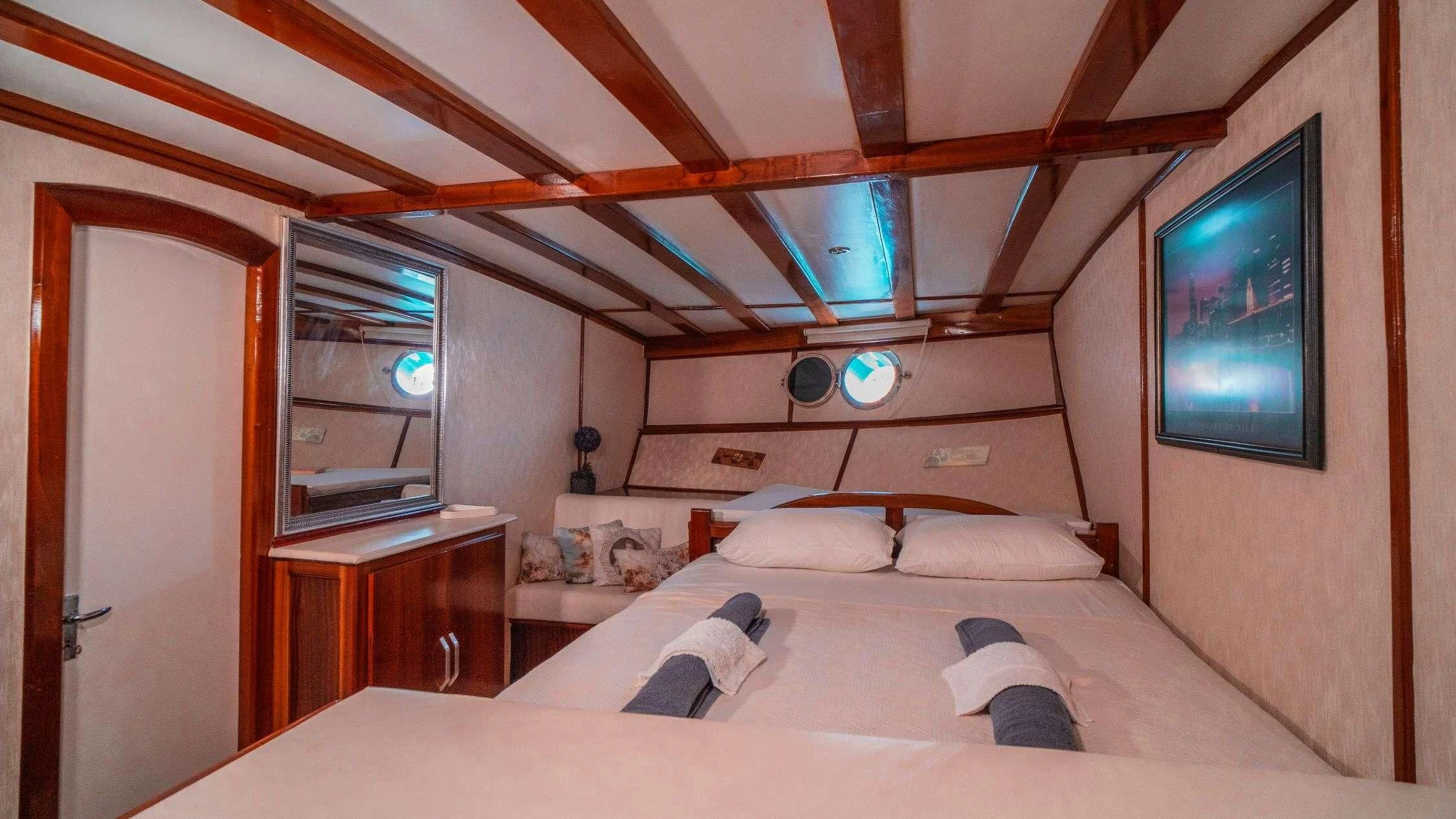 a room with a bed and a tv aboard WHITE SWAN Yacht for Sale