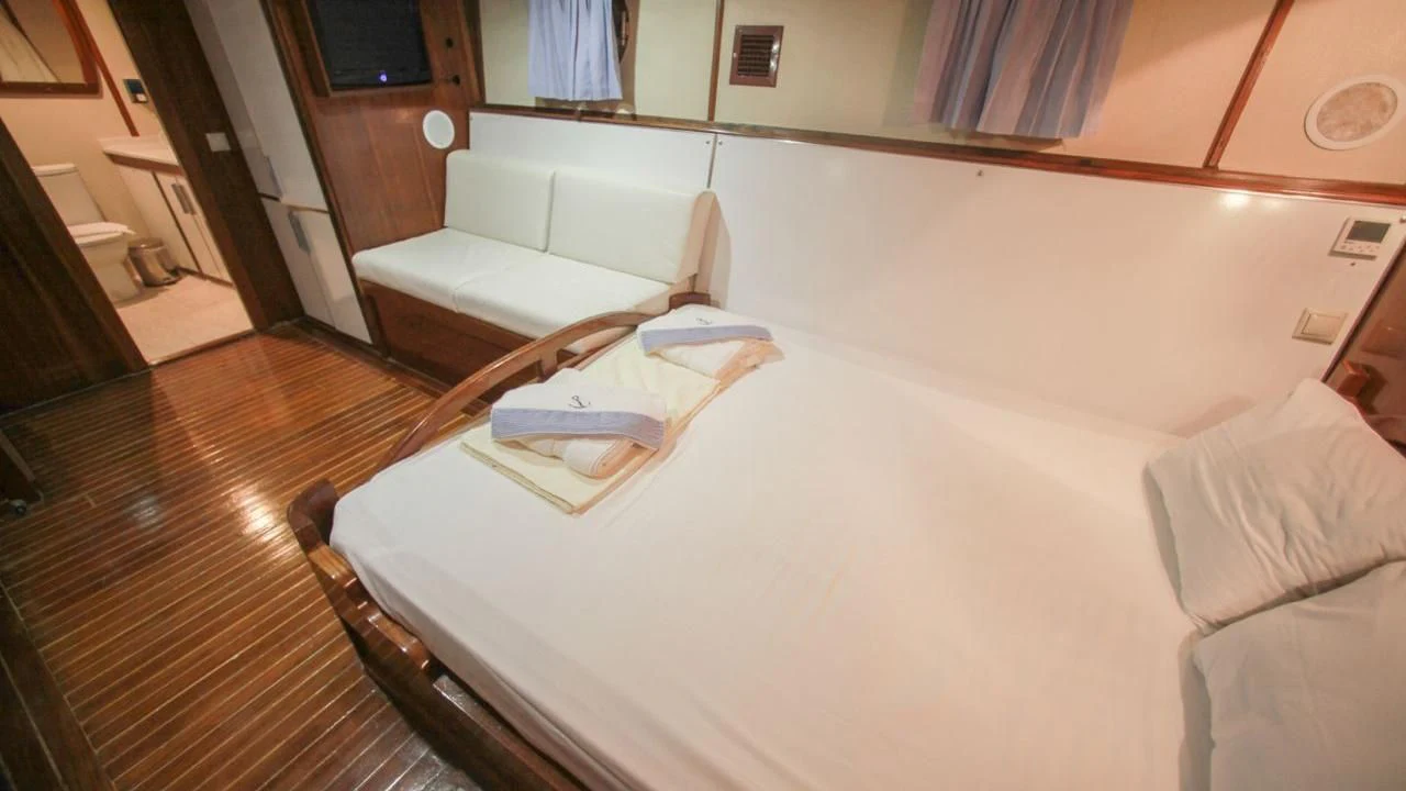 a bed in a room aboard WHITE SWAN Yacht for Sale