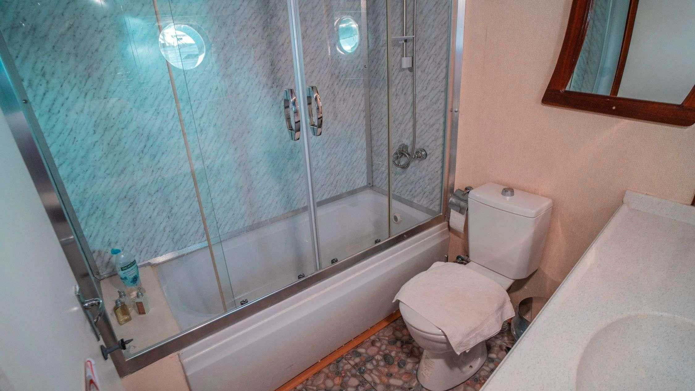 a bathroom with a glass shower aboard WHITE SWAN Yacht for Sale
