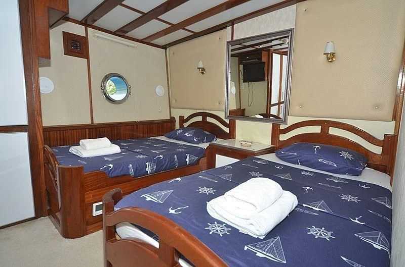 a couple of beds in a room aboard WHITE SWAN Yacht for Sale