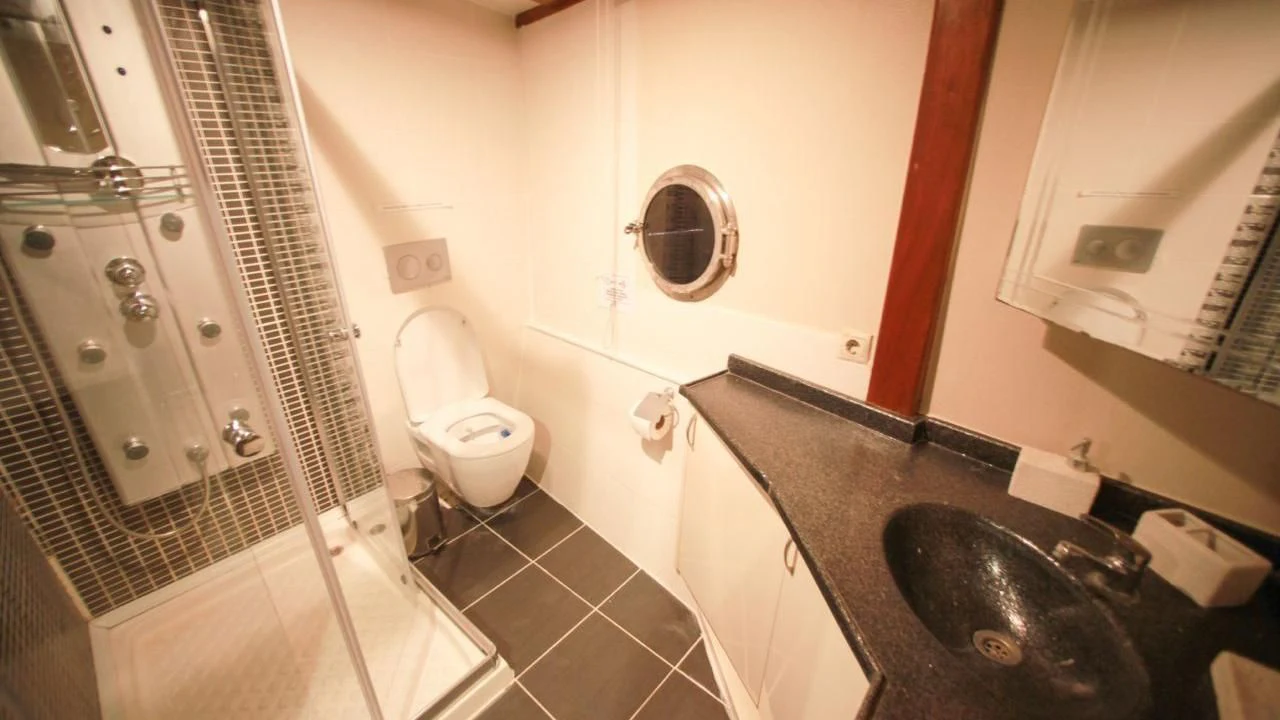 a bathroom with a sink and a toilet aboard WHITE SWAN Yacht for Sale