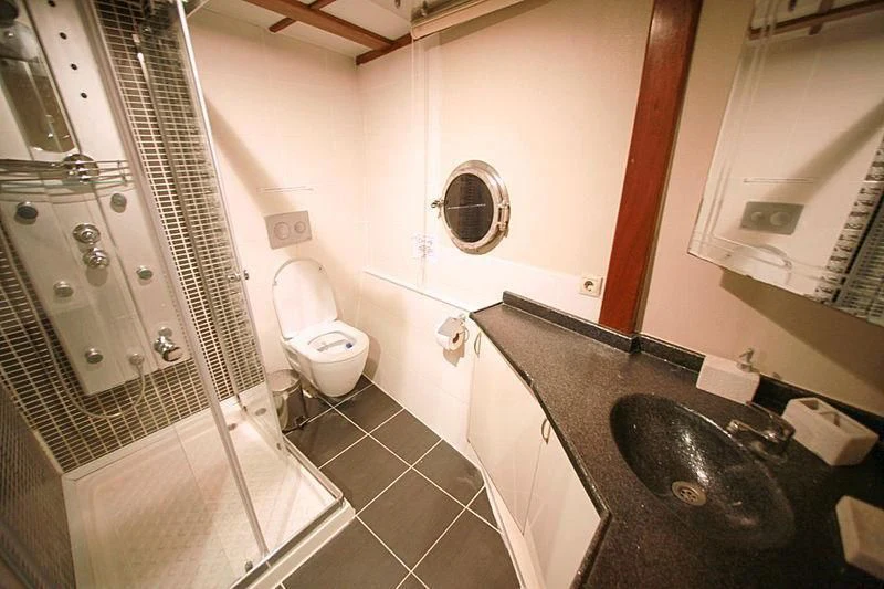 a bathroom with a sink and a shower aboard WHITE SWAN Yacht for Sale