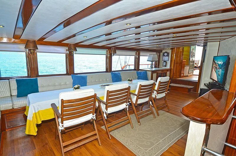 a room with a table and chairs aboard WHITE SWAN Yacht for Sale