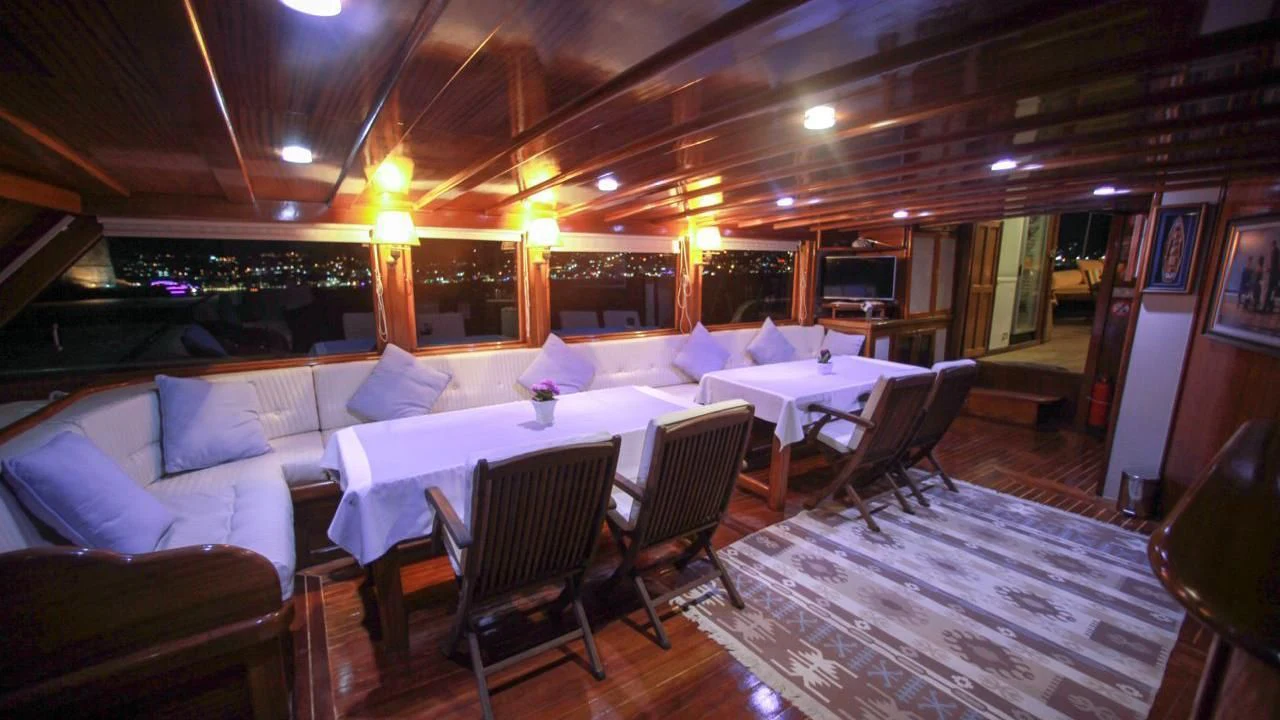 a large room with tables and chairs aboard WHITE SWAN Yacht for Sale