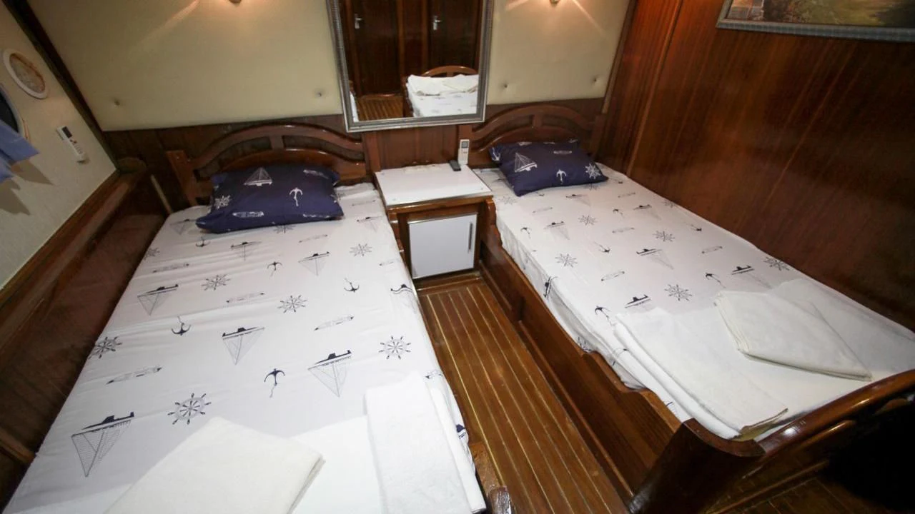 a couple of beds in a room aboard WHITE SWAN Yacht for Sale