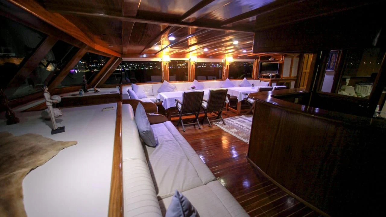 a room with a couch and tables aboard WHITE SWAN Yacht for Sale