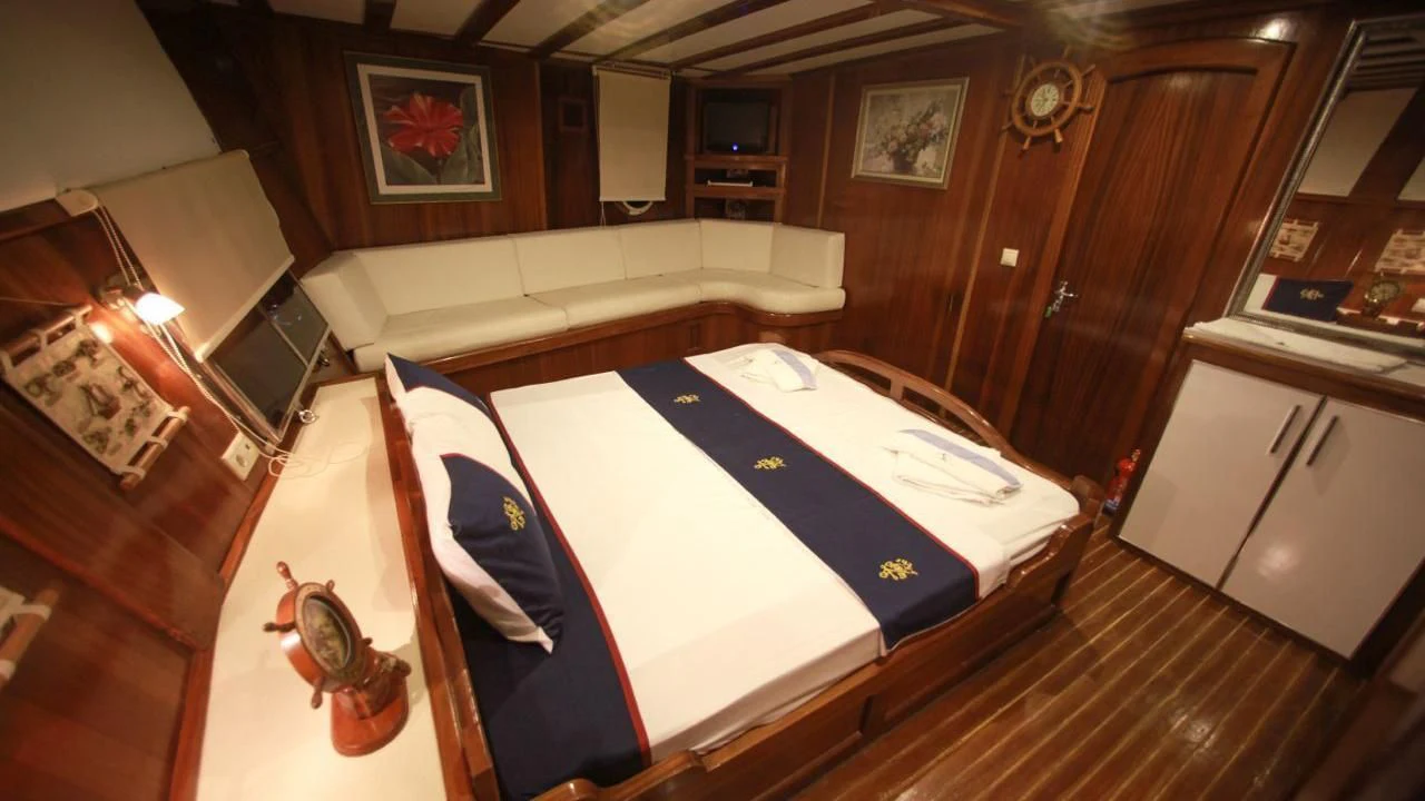 a bed in a room aboard WHITE SWAN Yacht for Sale