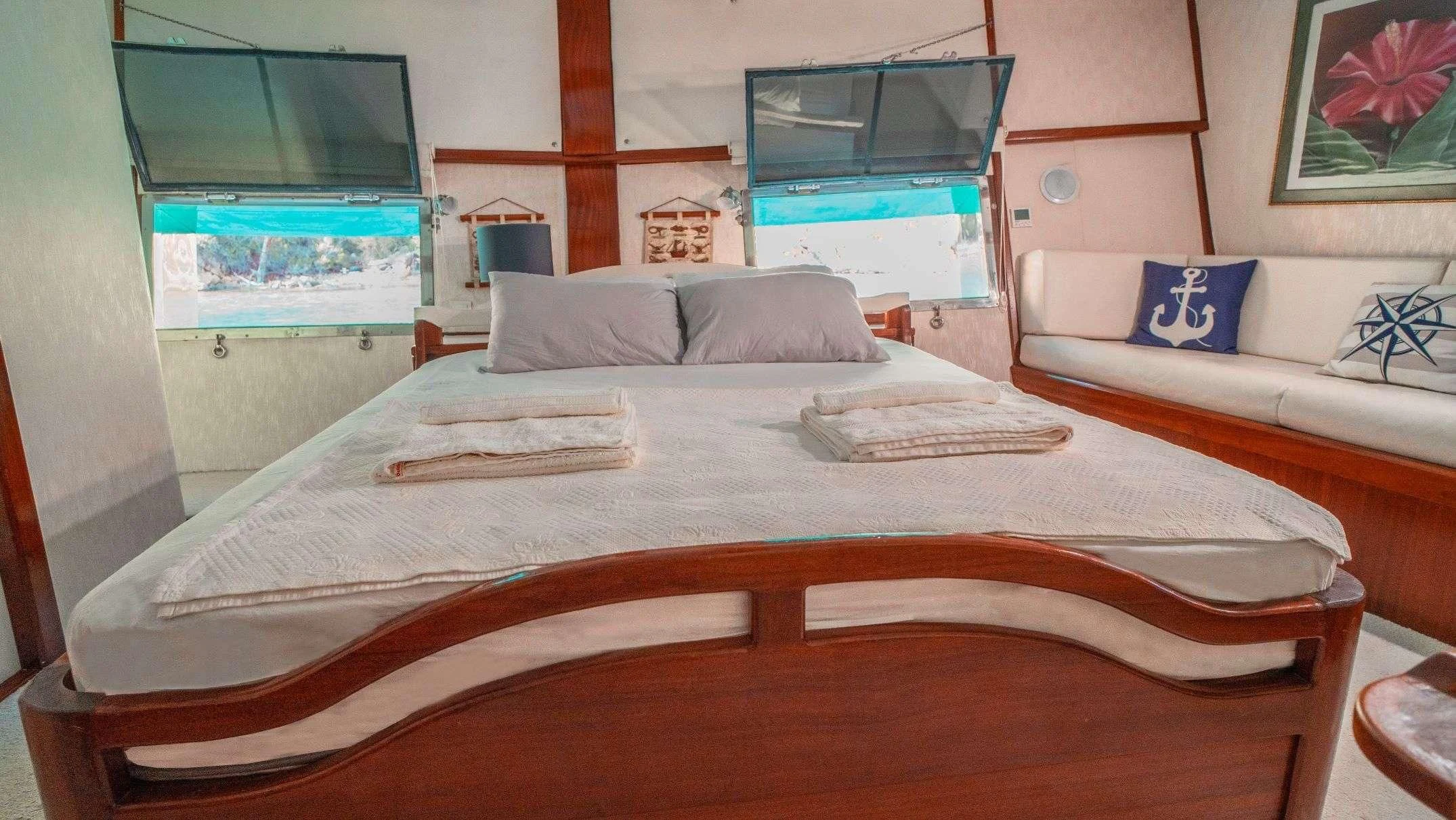 a bed with a white sheet and pillows aboard WHITE SWAN Yacht for Sale