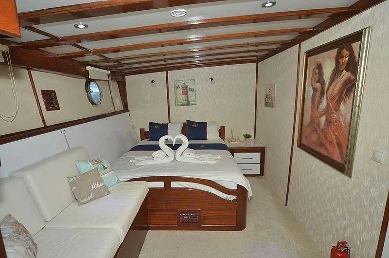 a room with a bed and a couch aboard WHITE SWAN Yacht for Sale