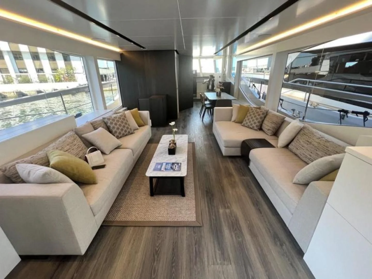 a living room with a couch and a table aboard NUMARINE 22XP/07 Yacht for Sale