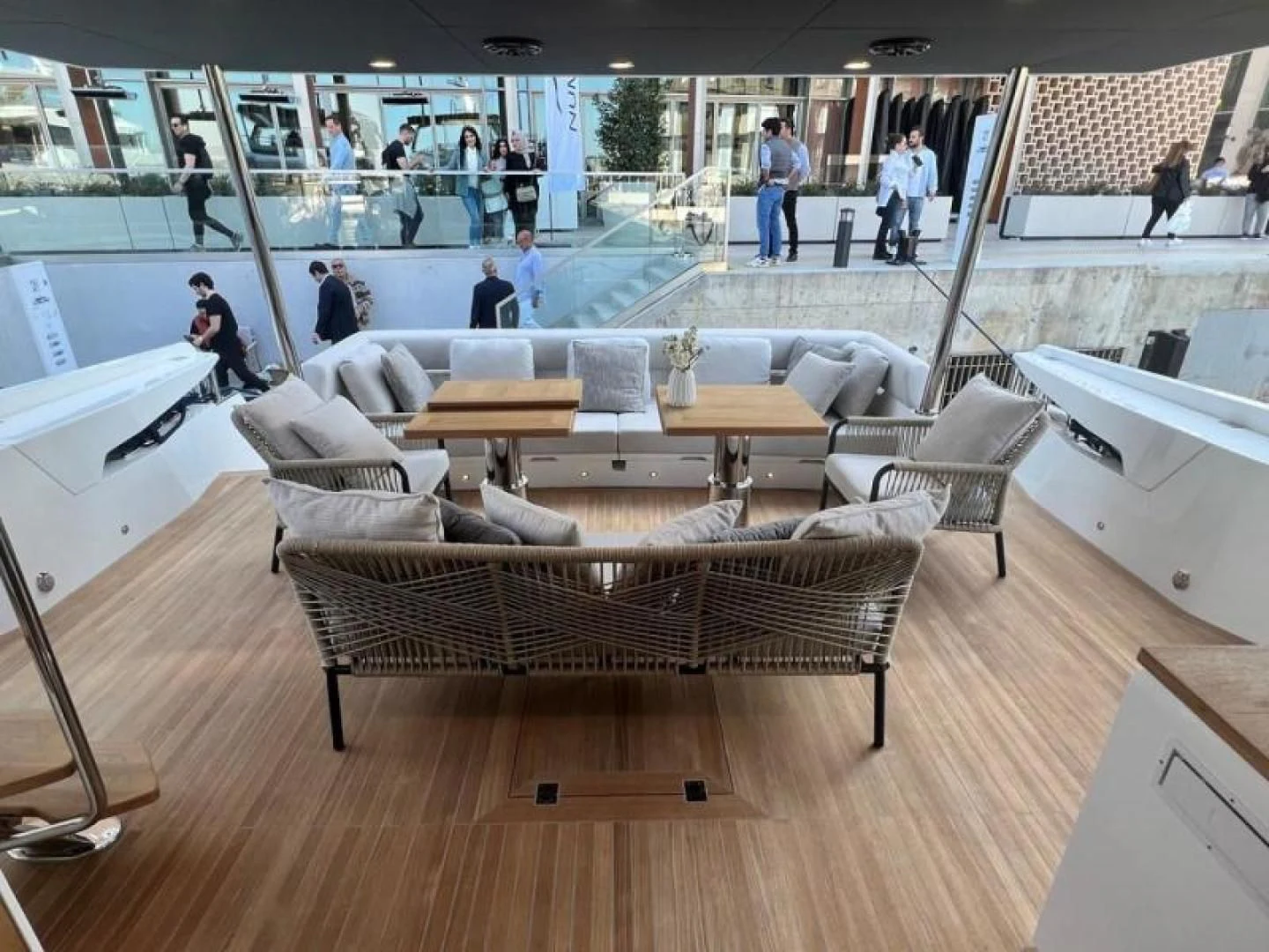 a room with a couch and a table with people standing around aboard NUMARINE 22XP/07 Yacht for Sale