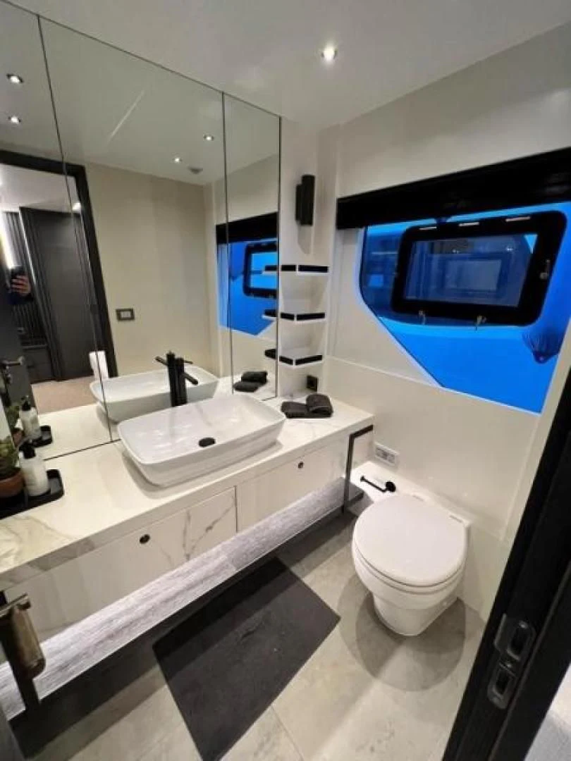 a bathroom with a large mirror aboard NUMARINE 22XP/07 Yacht for Sale