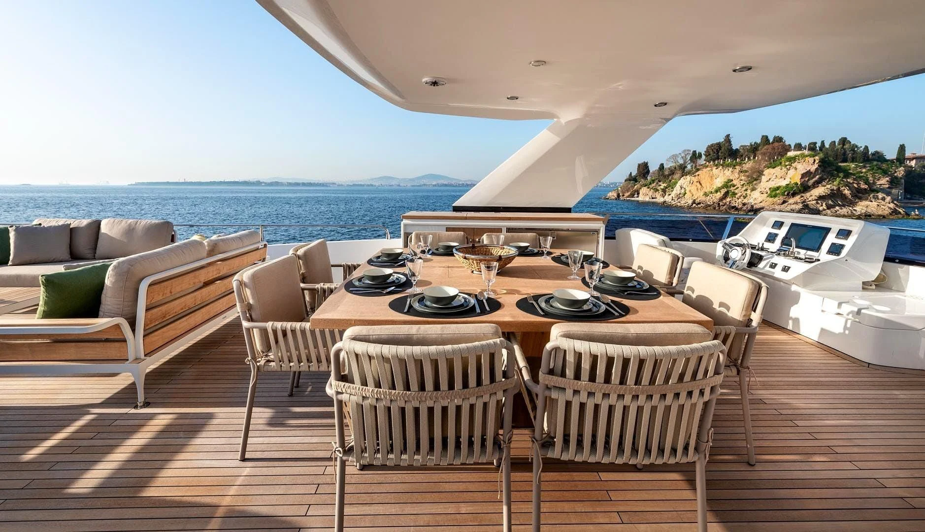 a table set for a meal on a deck overlooking a large body of water aboard NUMARINE 22XP/07 Yacht for Sale