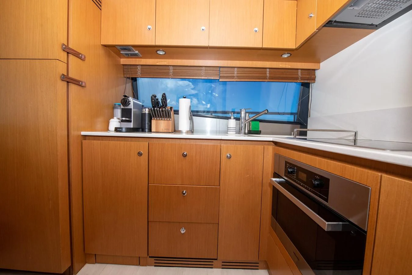 a kitchen with wooden cabinets aboard HOPE Yacht for Sale